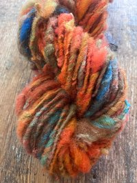 Mischievious - handspun local wool art yarn, orange with green, blue and pink
