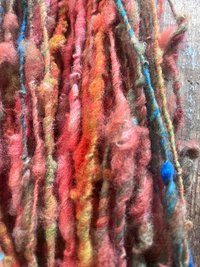 Mischievious - handspun local wool art yarn, orange with green, blue and pink