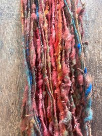 Mischievious - handspun local wool art yarn, orange with green, blue and pink