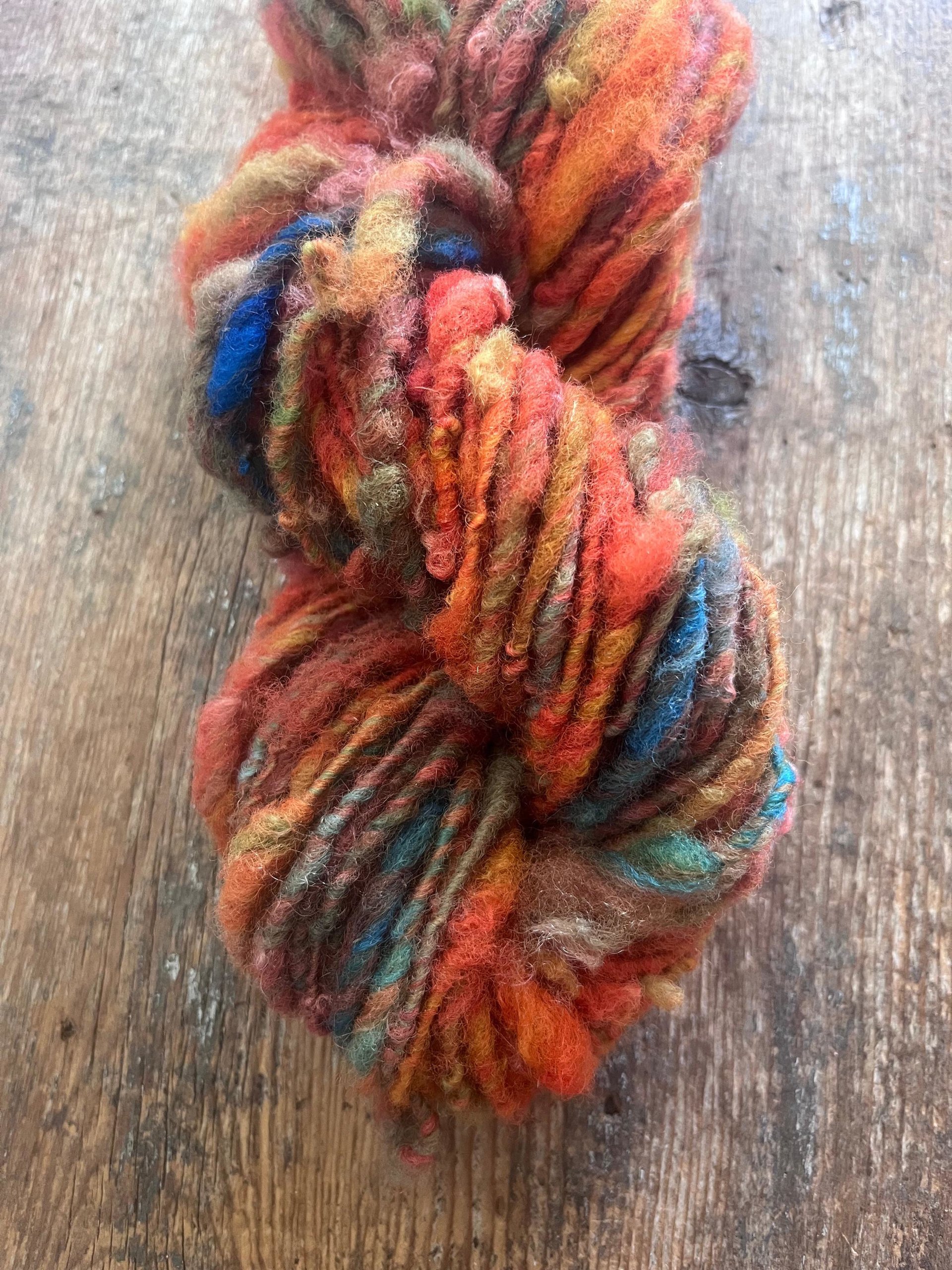 Mischievious - handspun local wool art yarn, orange with green, blue and pink