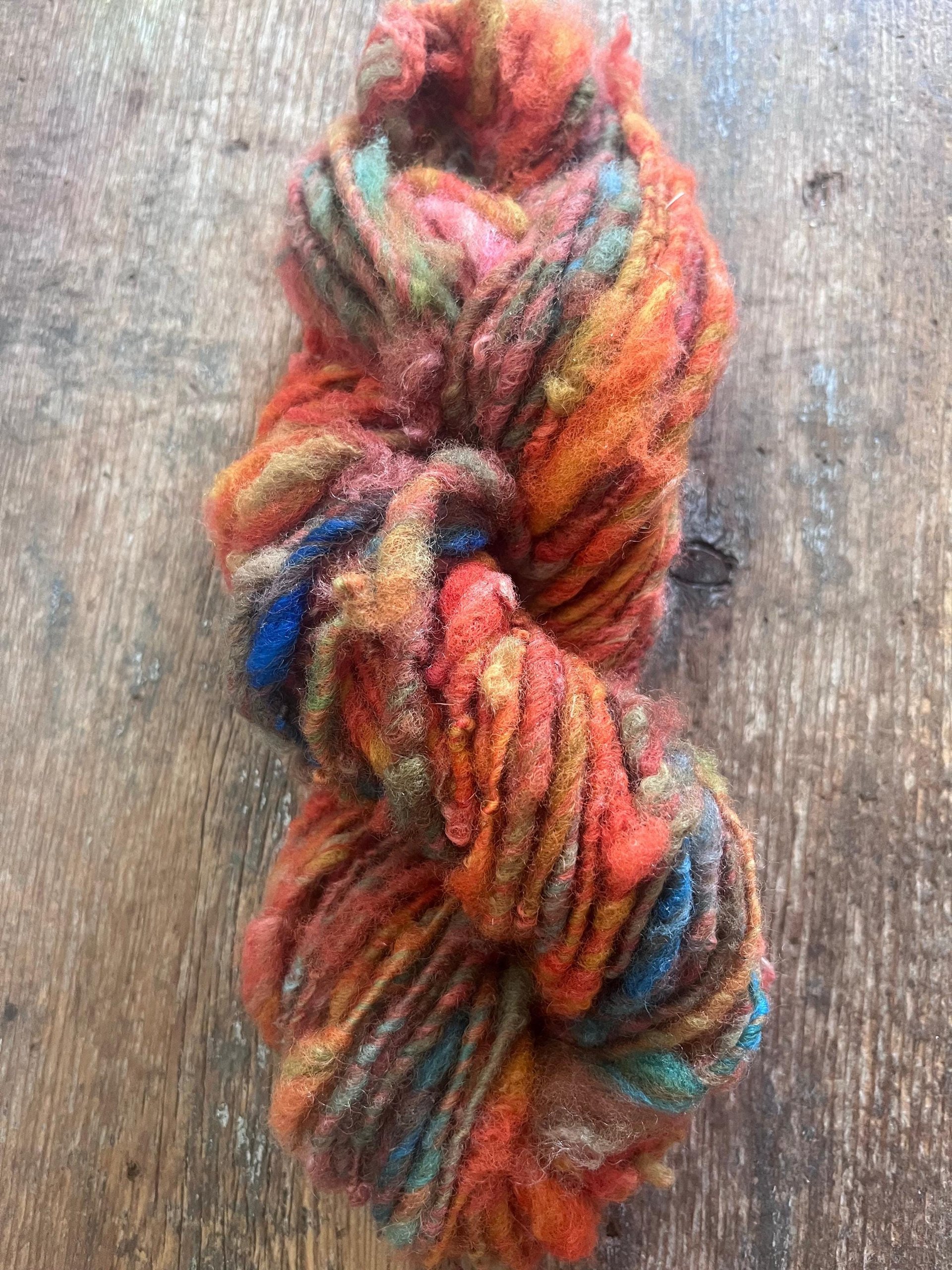 Mischievious - handspun local wool art yarn, orange with green, blue and pink