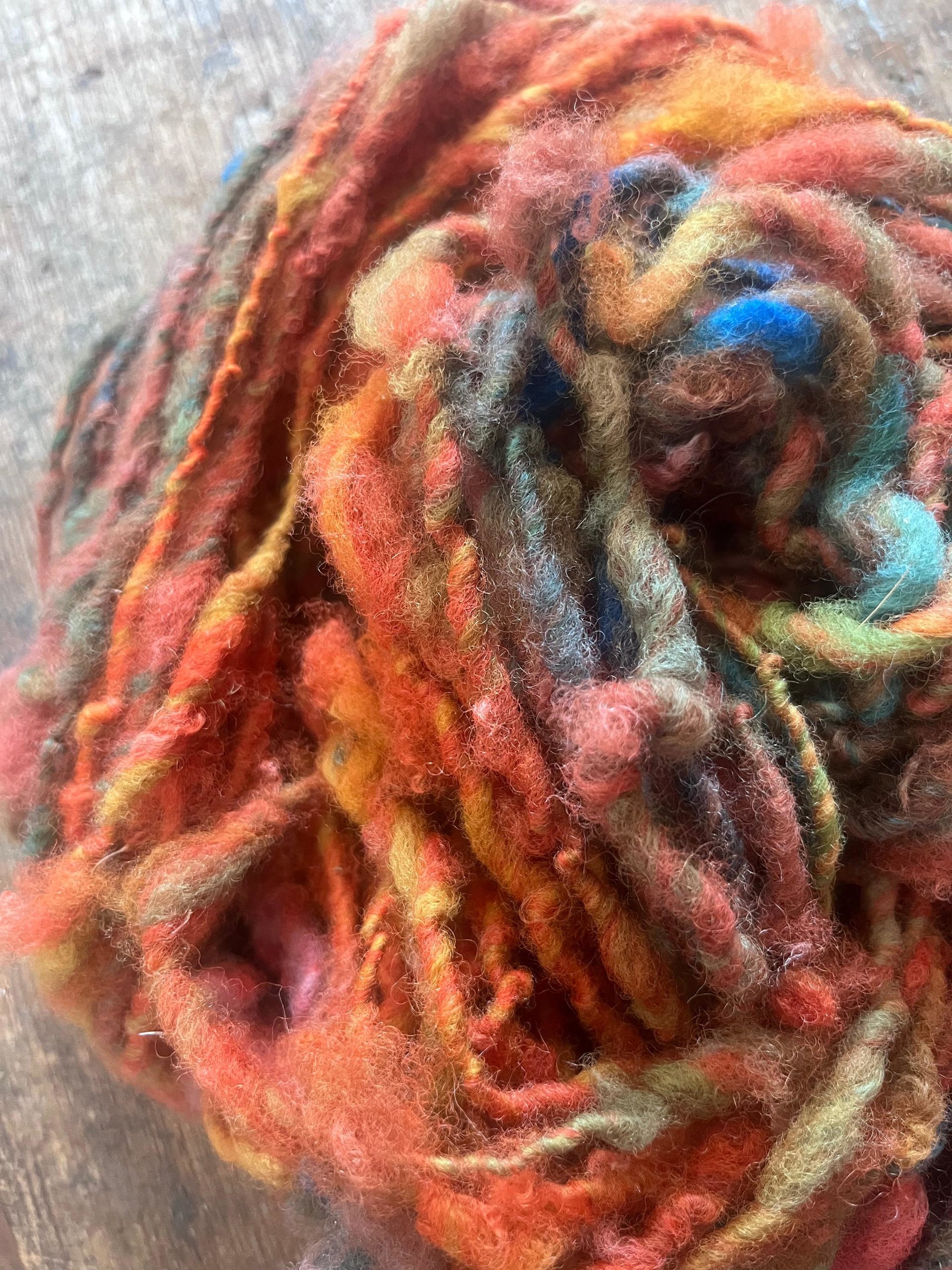Mischievious - handspun local wool art yarn, orange with green, blue and pink
