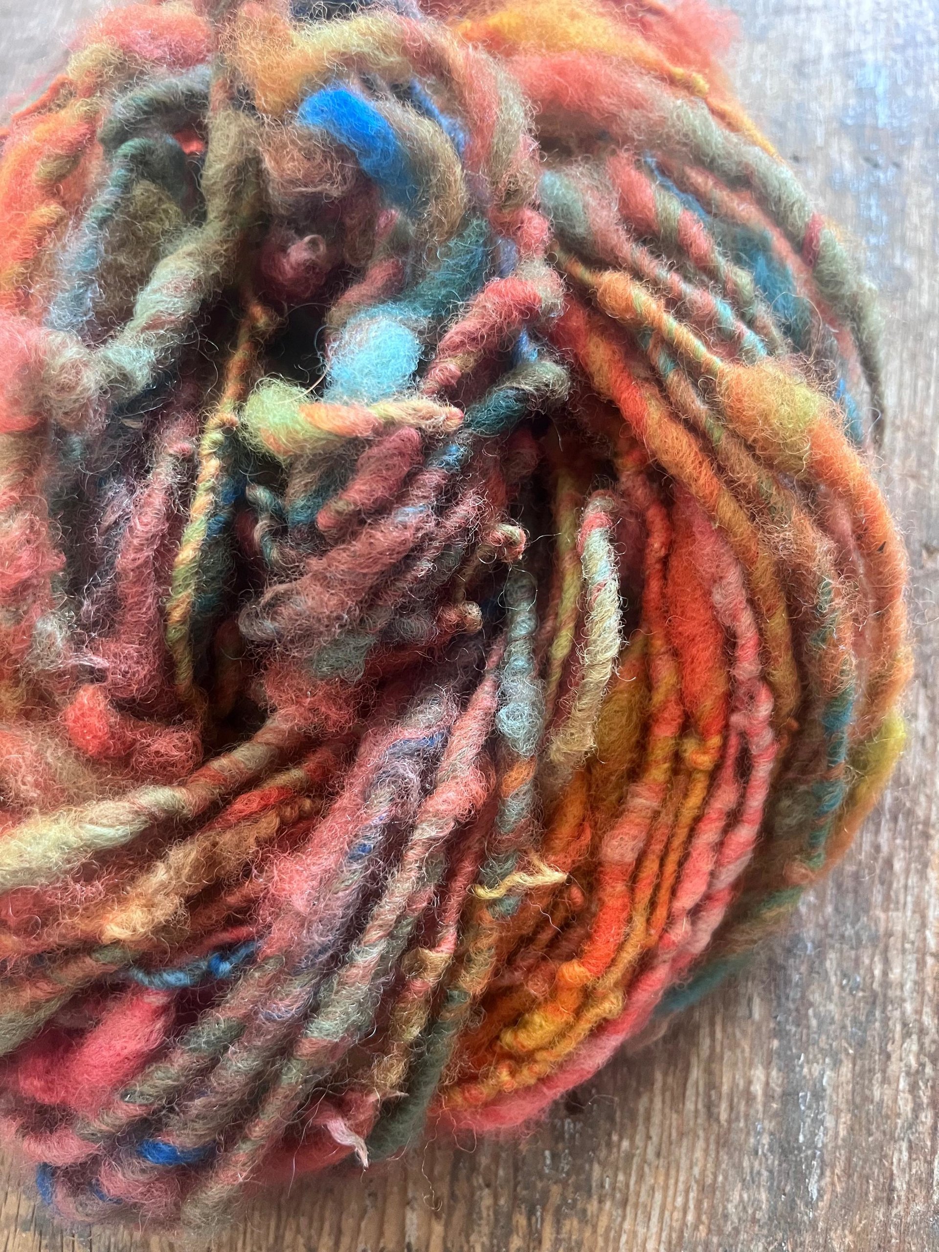 Mischievious - handspun local wool art yarn, orange with green, blue and pink