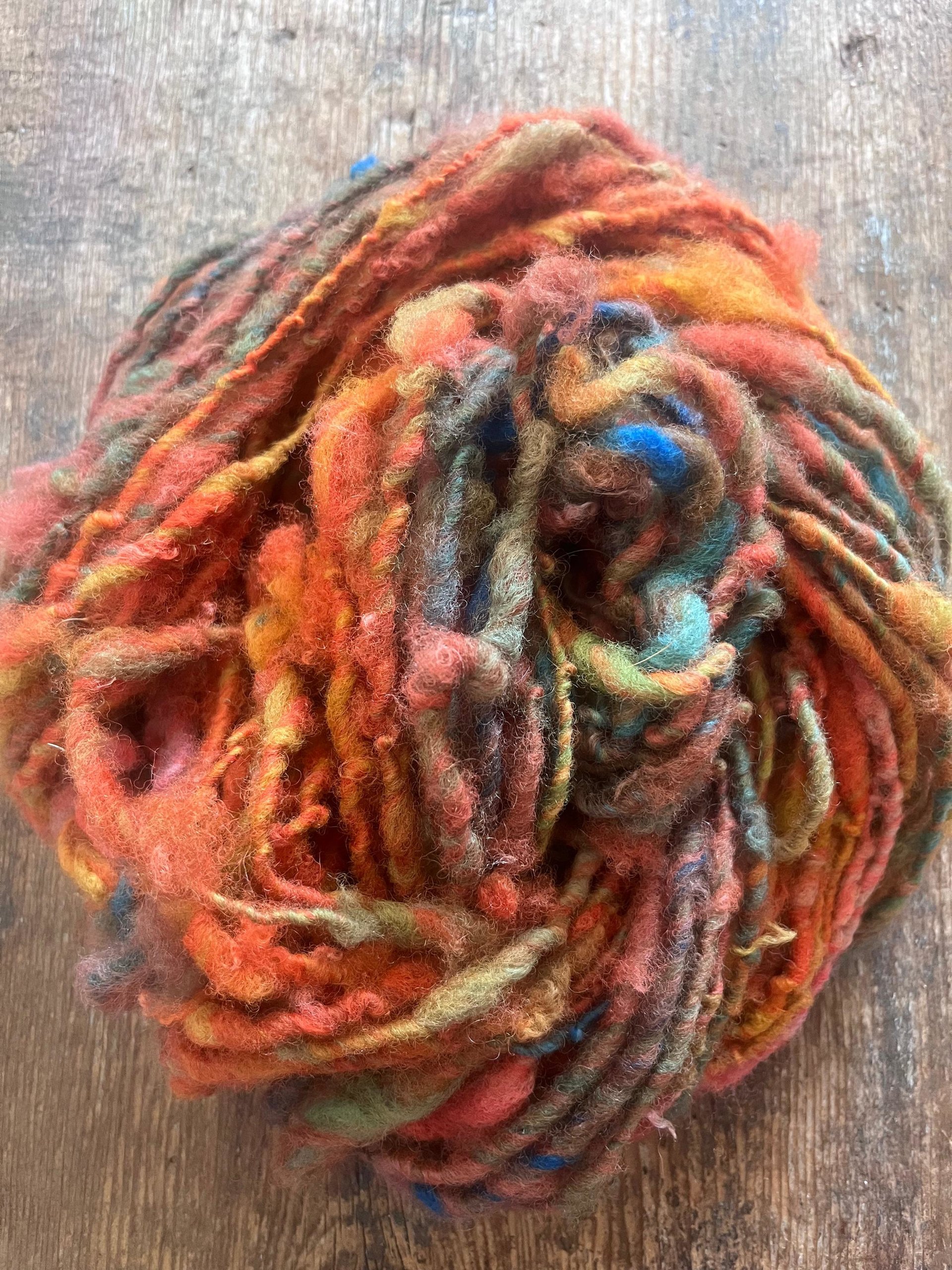 Mischievious - handspun local wool art yarn, orange with green, blue and pink