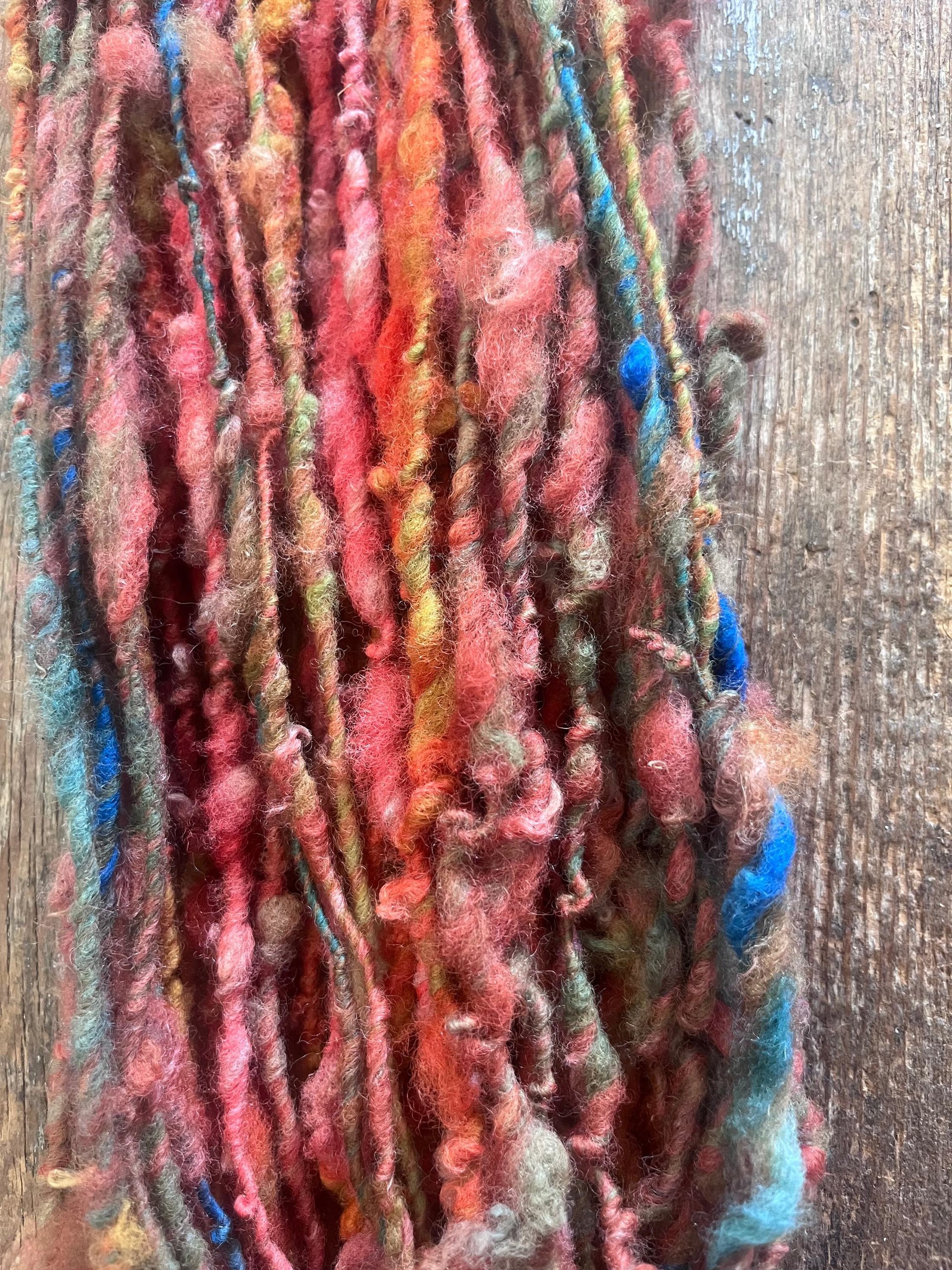 Mischievious - handspun local wool art yarn, orange with green, blue and pink