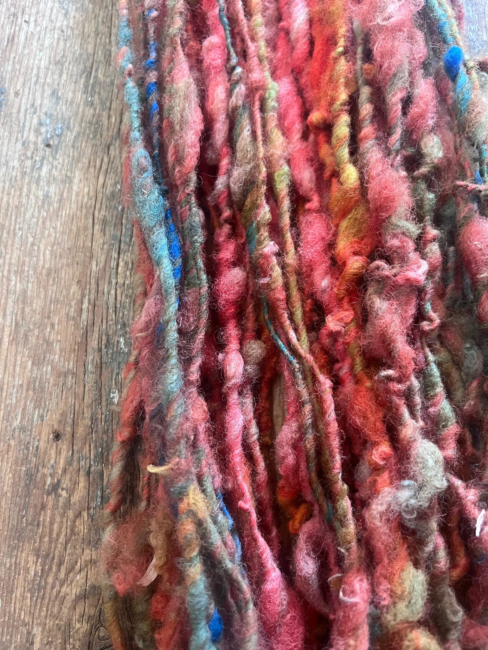 Mischievious - handspun local wool art yarn, orange with green, blue and pink